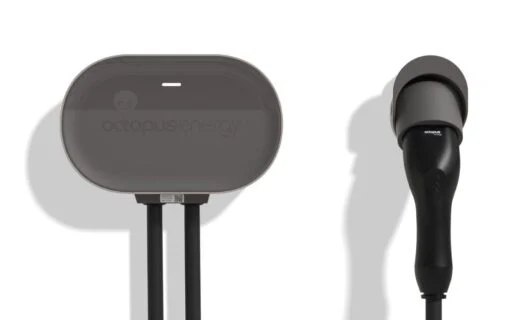 a white wall with a black EV charger on it
