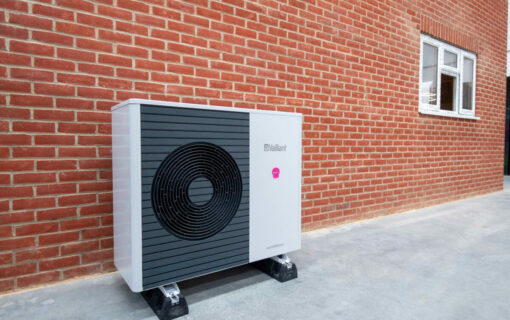 An Octopus Energy Heat Pump against a brick wall