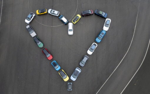 Cars in a heart shape shot from above