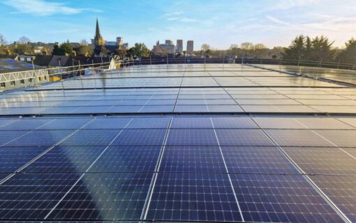 a data centre with solar panels on the roof and a city in the background