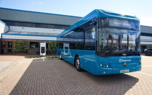 an electric bus next to an EV charger