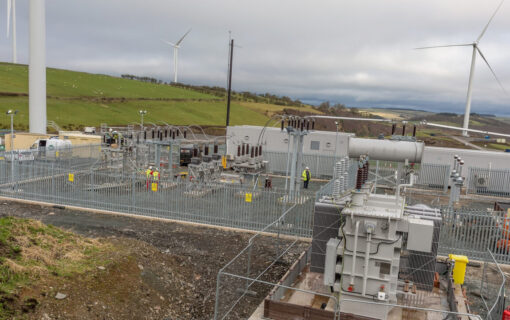 An electricity substation next to wind turbines