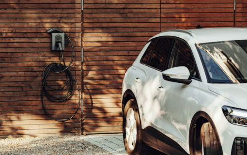 image of VW SUV parked against a brick wall charging at a chargepoint,