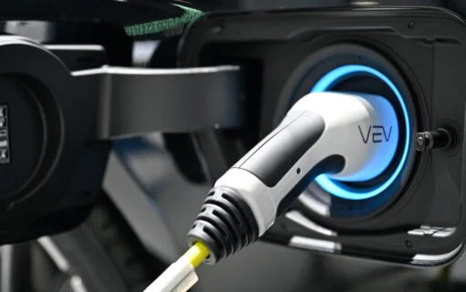 a VEV branded EV charger plugged into a vehicle, close up