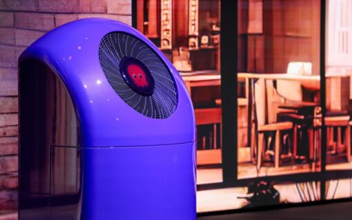 A heat pump branded with the Octopus logo outside a home at night