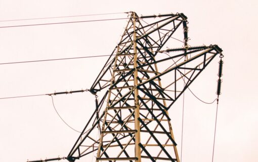 a rusty pylon against a white sky