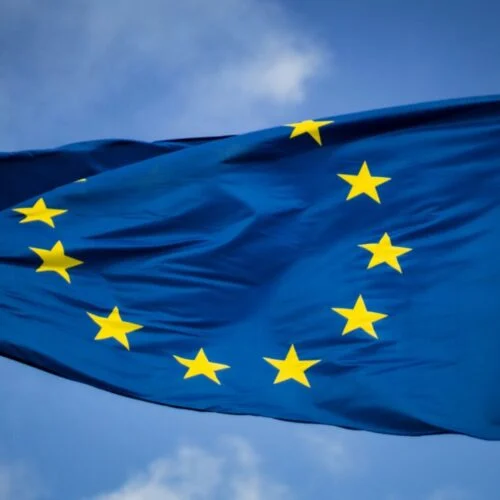 an EU flag flying in a blue sky