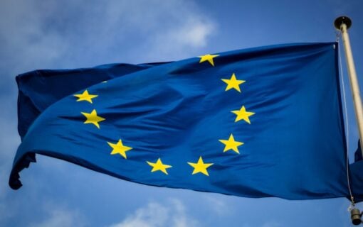 an EU flag flying in a blue sky