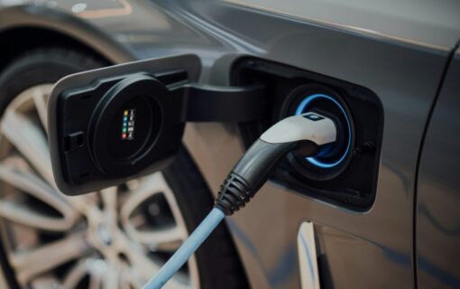 a close up of an ev plugged in to charge