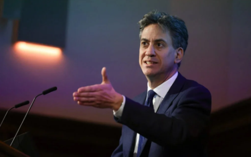 ed Miliband stands by a podium