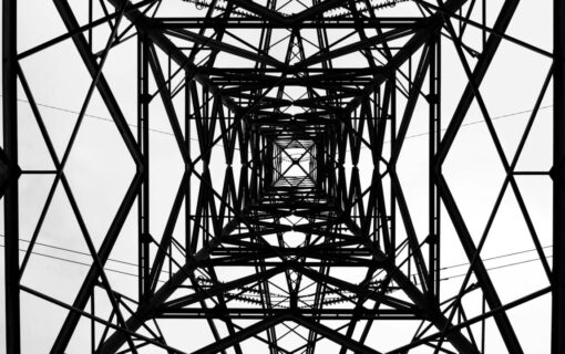an electric pylon shot from underneath in black and white