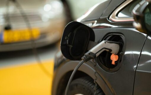 a close up of a charger plugged into an EV