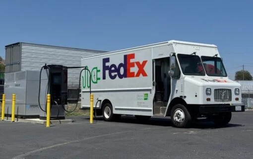 a truck with the fedex logo plugged into an EV charger
