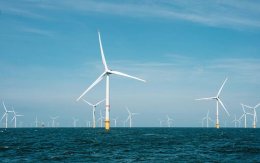 Offshore wind turbines under a blue sky