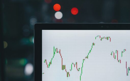 a laptop screen showing a graph going up and down
