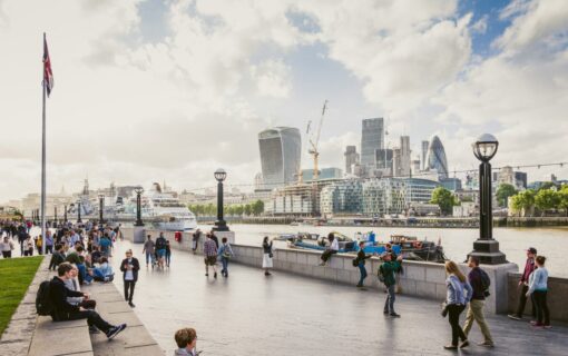 a view of the river Thames with several iconic modern buildings behind it