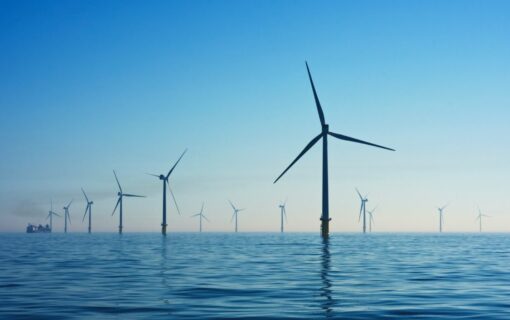 Wind turbines in a dusky blue sea