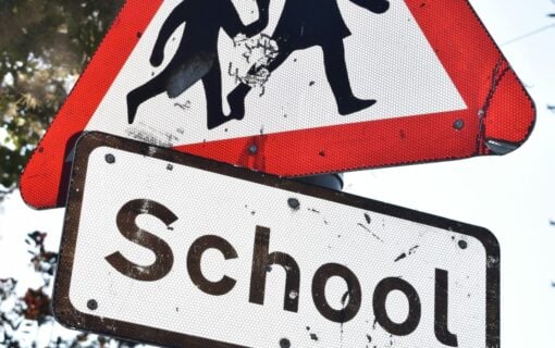 a close up on a school traffic warning sign