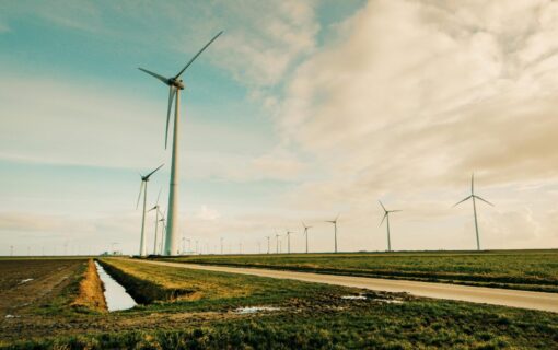 Wind turbines along a road in the early evening