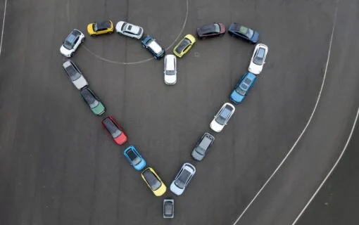 a number of different BEV cars parked in a heart shape