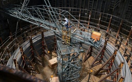 A worker constructs HVDC cables at a large facility