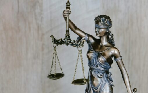a statue of a blindfolded woman holding scales, used to represent the law
